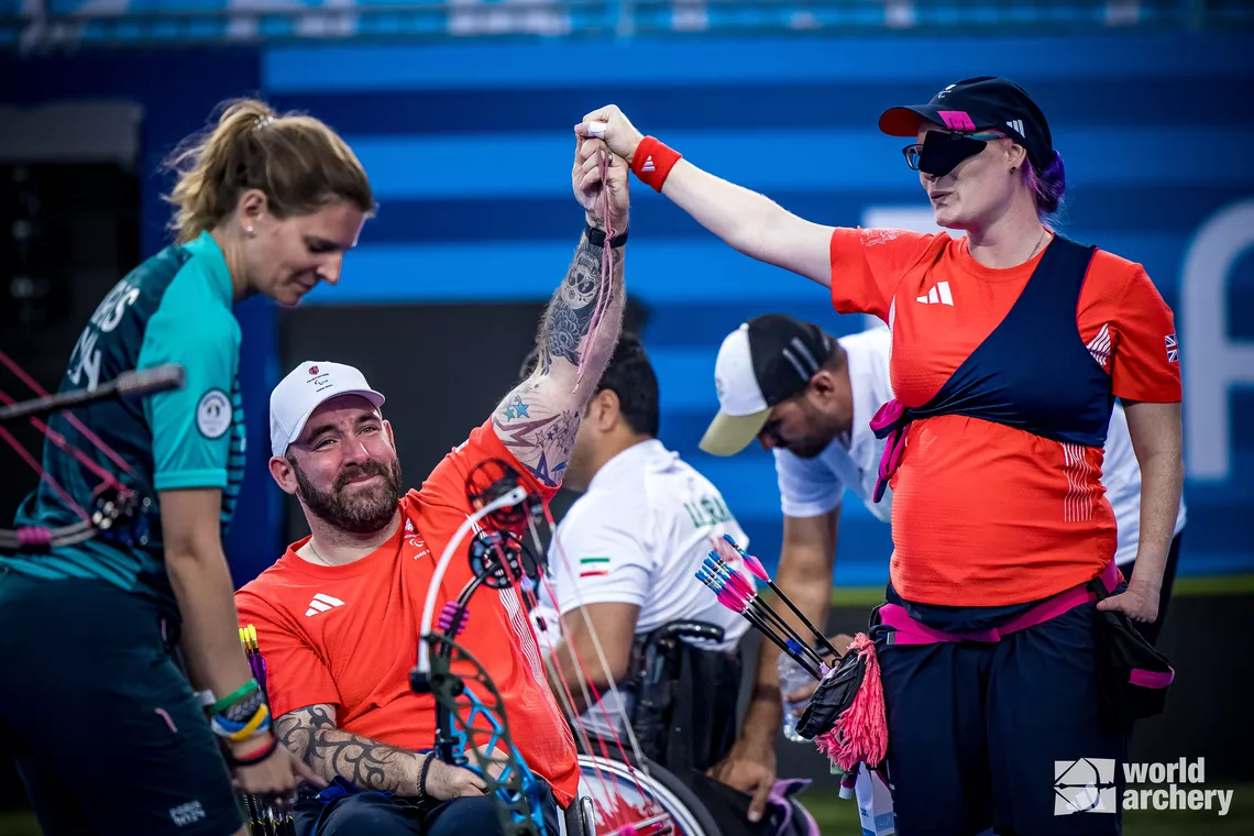 Nathan MacQueen and Jodie Grinham celebrating together after winning gold.
