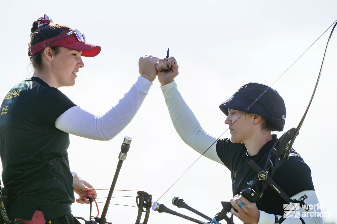 Lexie Feeney fist bumping teammate Alyssa Mollema.