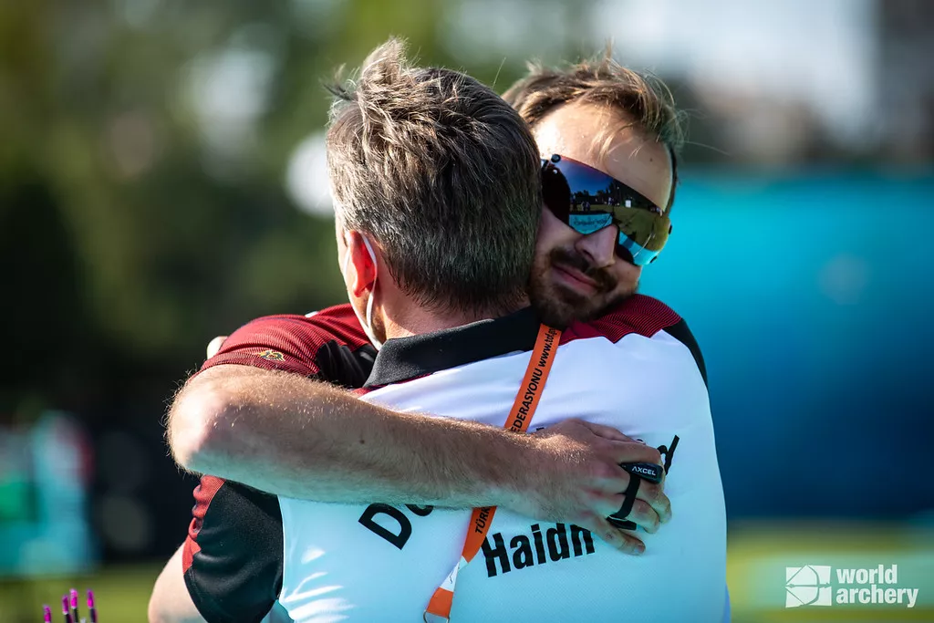 Florian Unruh embraces national coach Oliver Haidn after qualifying for the Tokyo 2020 Olympic Games. 