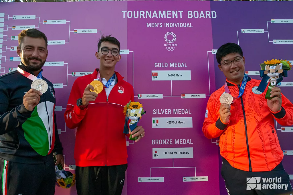 Mauro Nespoli, Mete Gazoz and Takaharu Furukawa pose with their medals at the Tokyo 2020 Olympic Games. 