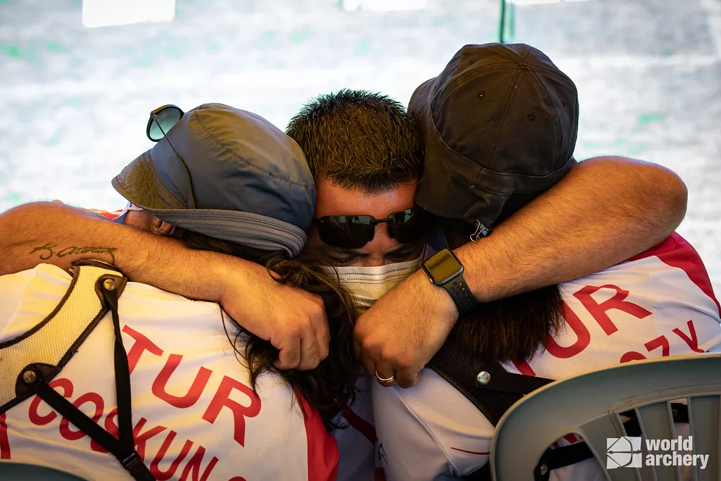 Goktug Ergin embraces Yasemin Anagoz and Gulnaz Coskun at the Antalya 2021 European Championships.