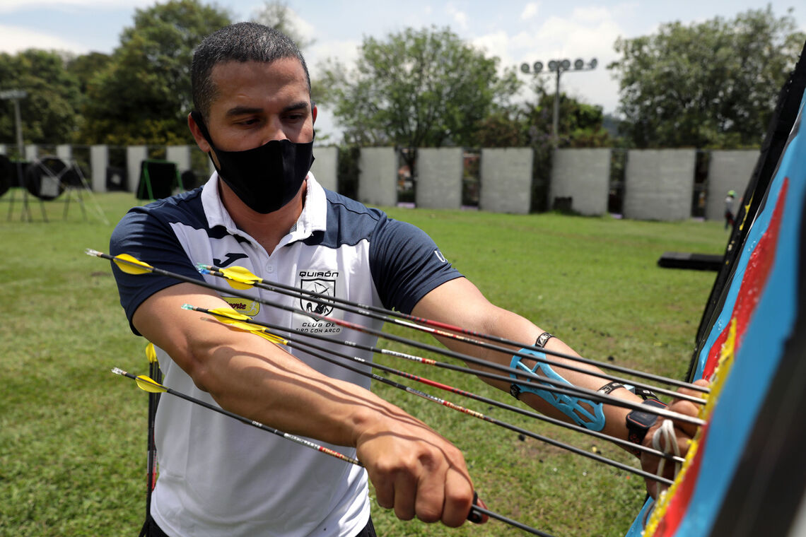 Danny Quintero collects arrows at the practice field in Medellin, Colombia.