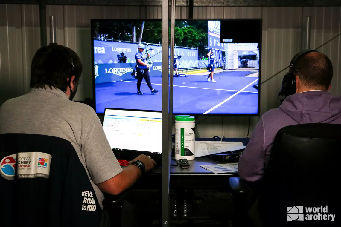 The remote results technician and world feed producer monitor a live feed.
