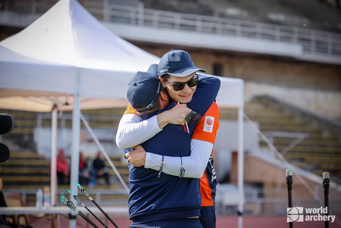 Willem Bakker hugs his coach after beating Henckles to gold.
