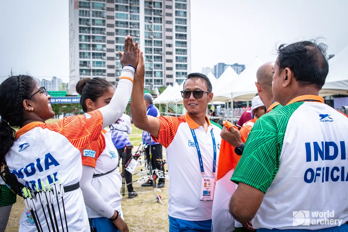 Komalika Bari high fives Tarundeep Rai after her team wins bronze.