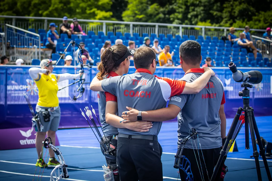 The Turkey mixed compound team wait to celebrate their gold medal at Munich 2022