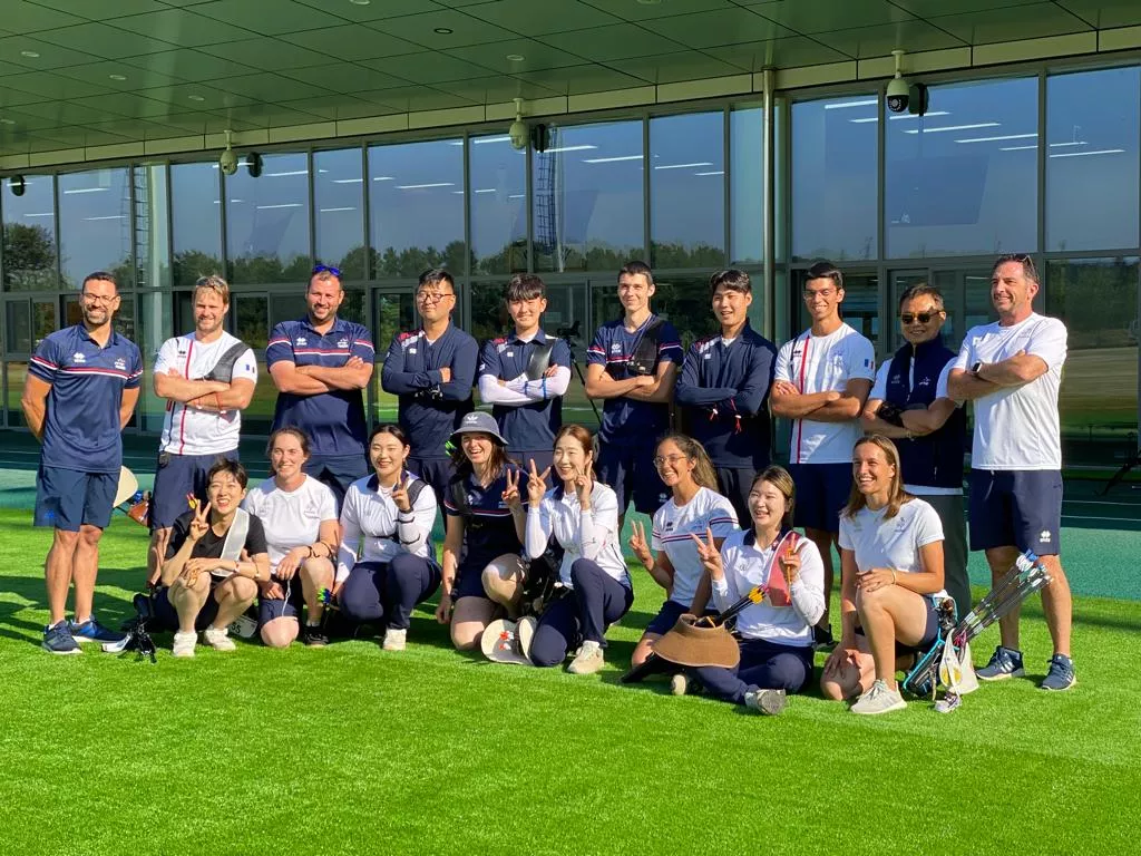French and Korean national teams posing together.
