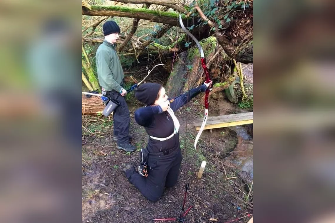 Ella Gibson trying field archery with a barebow.