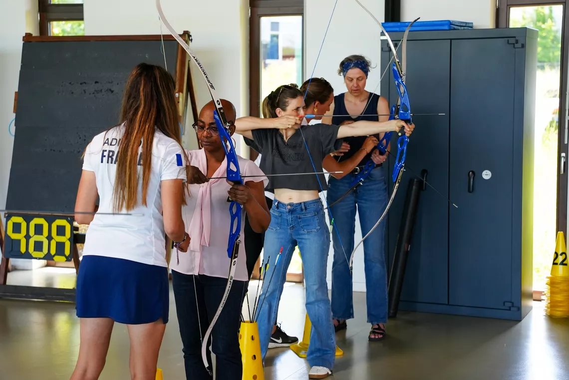 Participants having a go at shooting arrows.