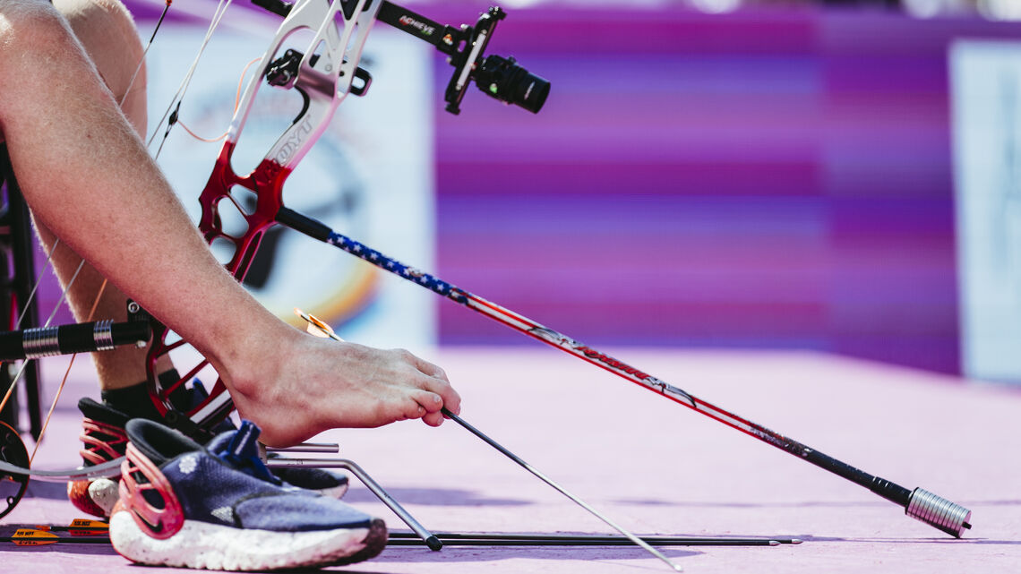 Matt Stuzman nocking arrow with his feet.