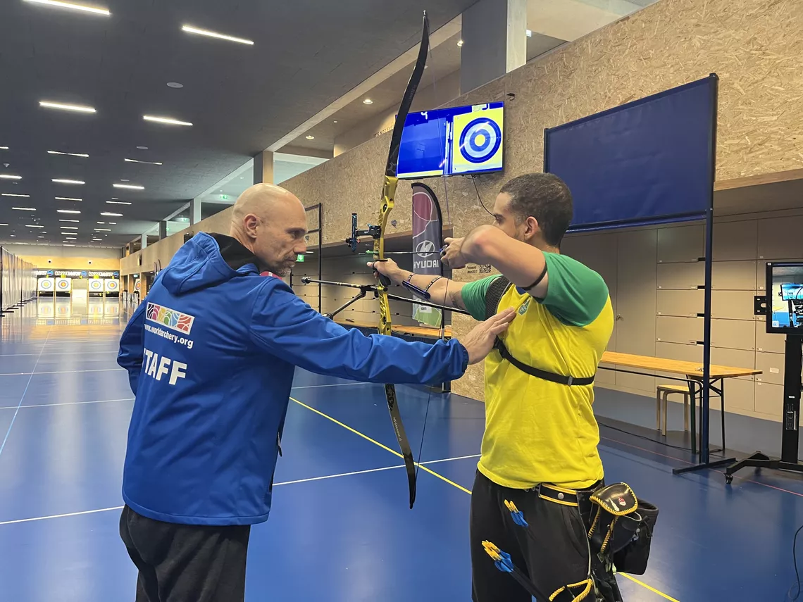 Marc Dellenbach correcting Bernardo Oliveira’s shooting position.