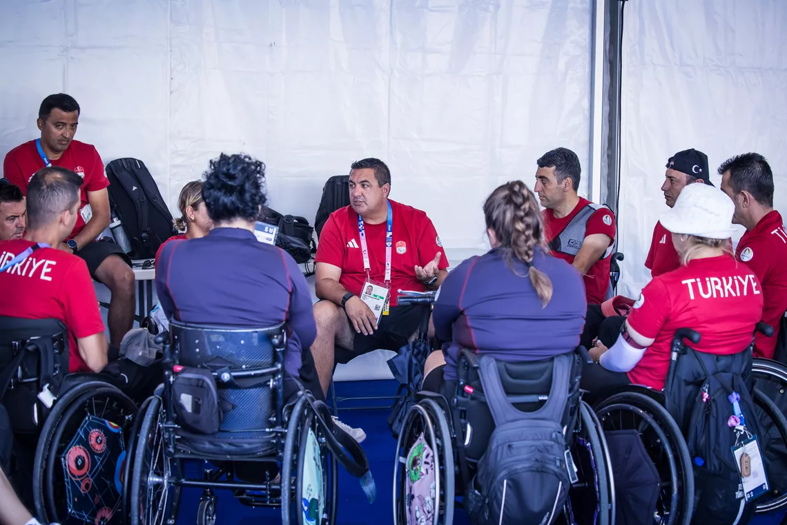Yusuf Goktug Ergin talking to the Turkish para archery team.