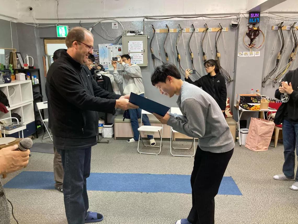 Andrew White awarding a student in a KTA competition.