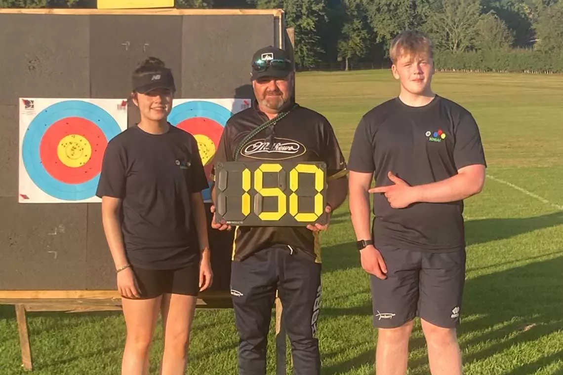 Marty McCullough (centre) with two students.