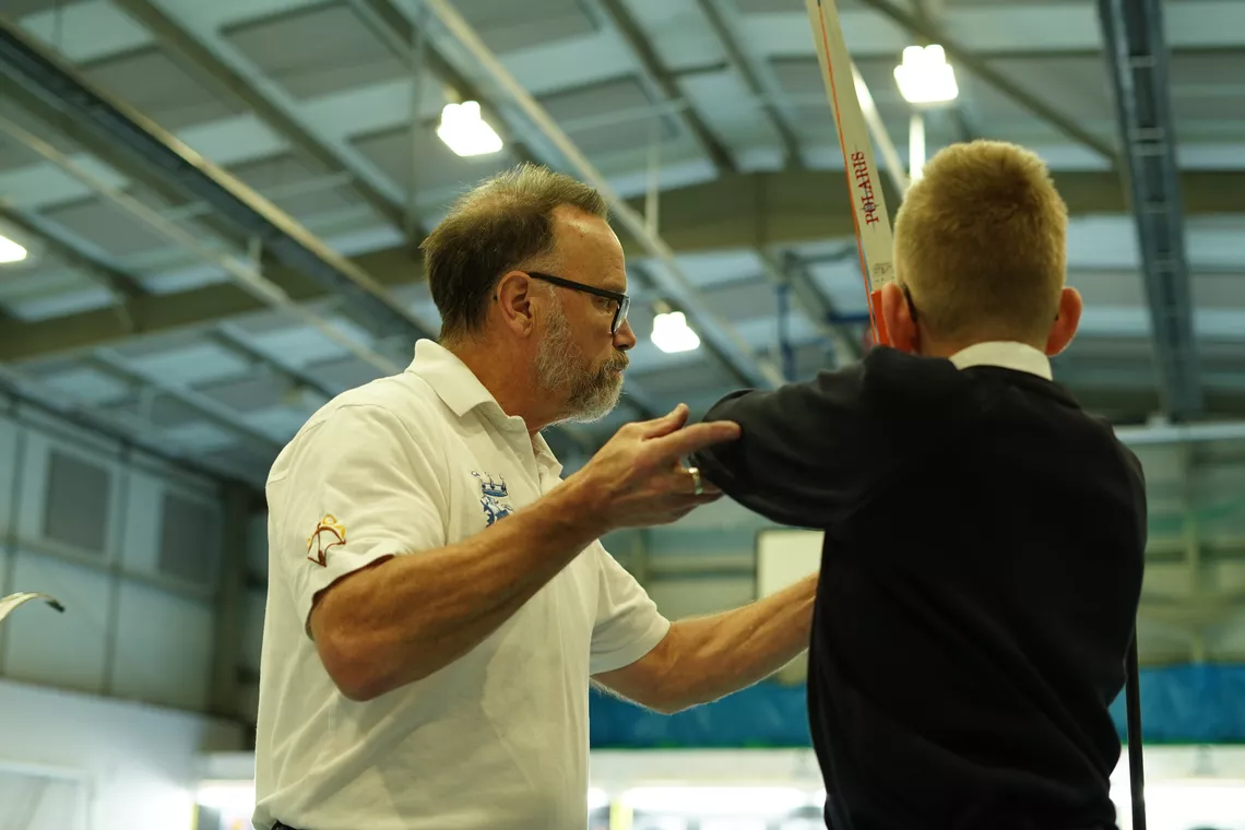 Adam Kenyon helping a student's form.