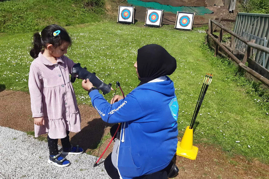 Jamila Bi helping a child before shooting.