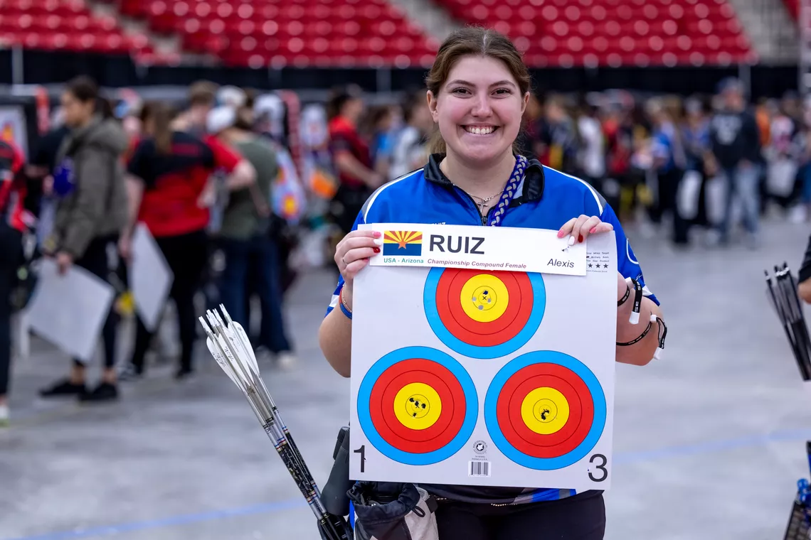 Alexis Ruiz holding up her target from the 2024 Vegas Shoot.