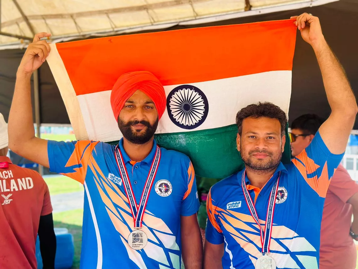 Harvinder Singh and Vivek Chikara celebrate team silver medal at 2023 Asian Para Championships.