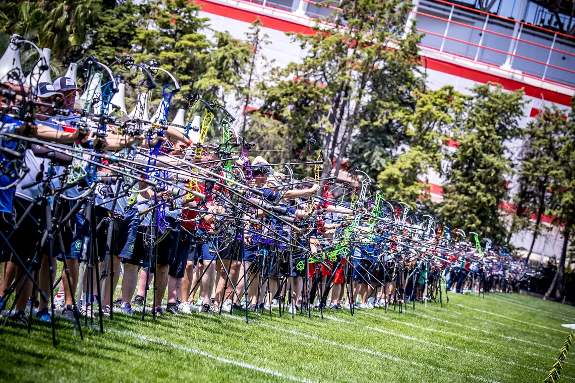 Compound archers aiming.