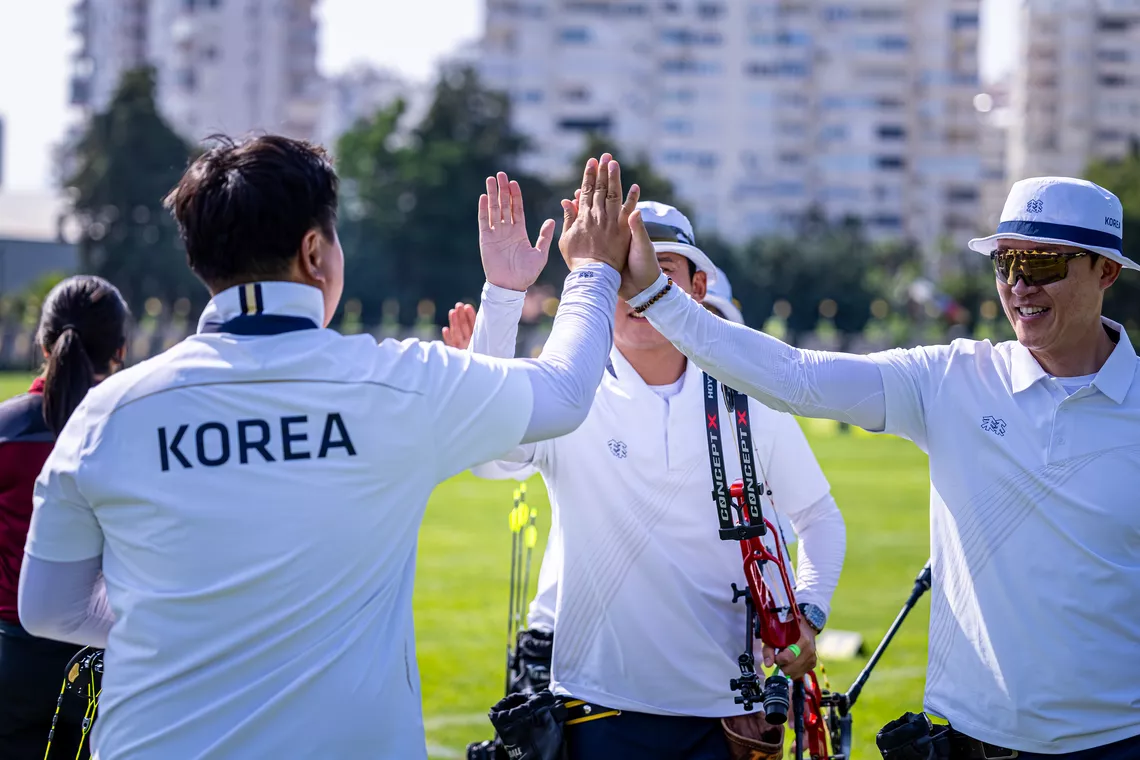 Korean compound men's team celebrating after winning bronze.