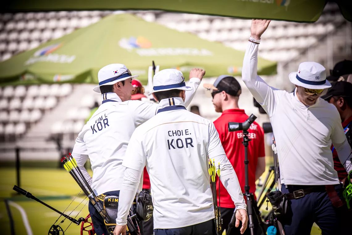 Korea compound men's team celebrating.
