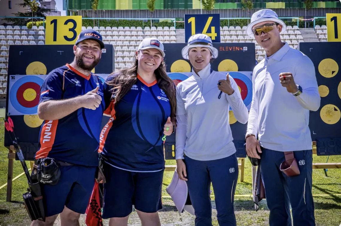 Netherlands and Korea posing together at targets.