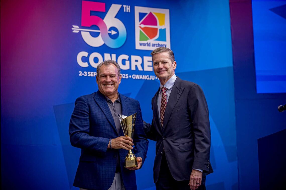 USA Archery CEO Rod Menzer receives nations’ trophy from new president Greg Easton.