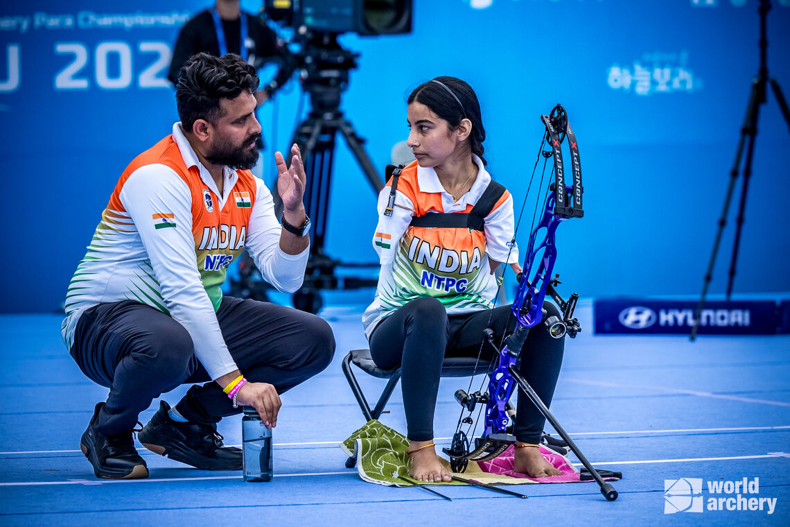 Coach talks to the archer in between the game 