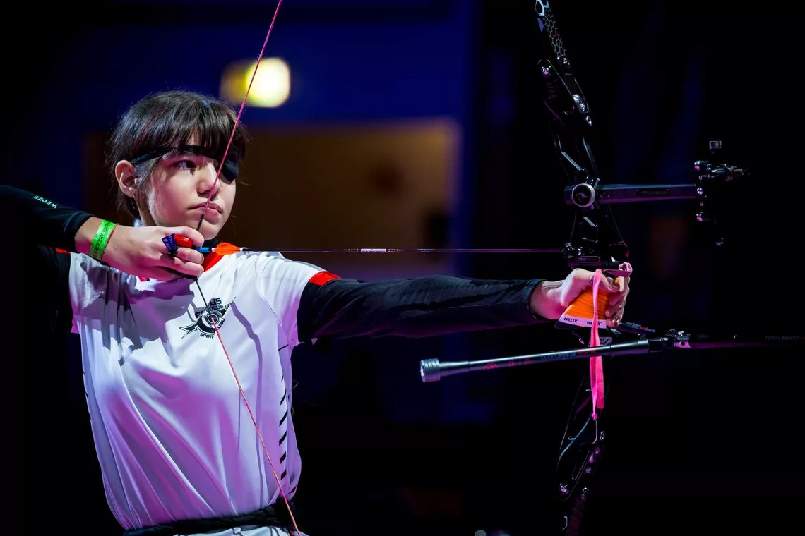Youth archer shooting at Nimes indoor tournament.