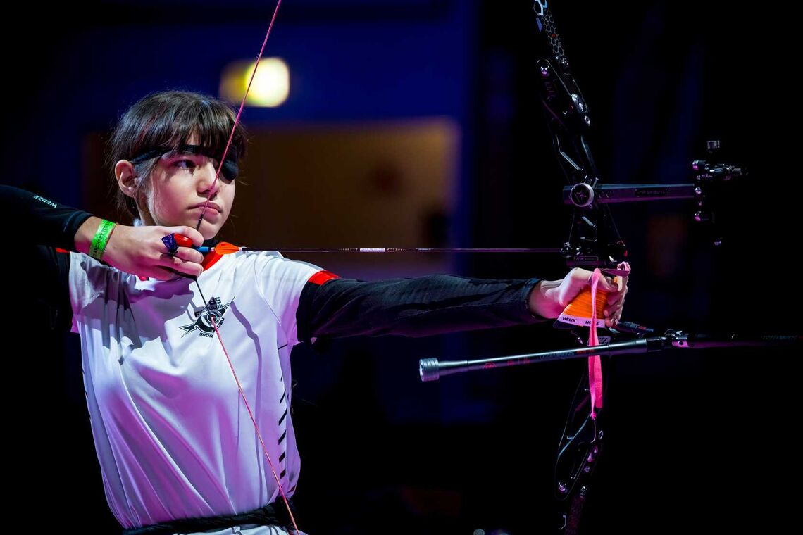 Youth archer shooting at Nimes indoor tournament.