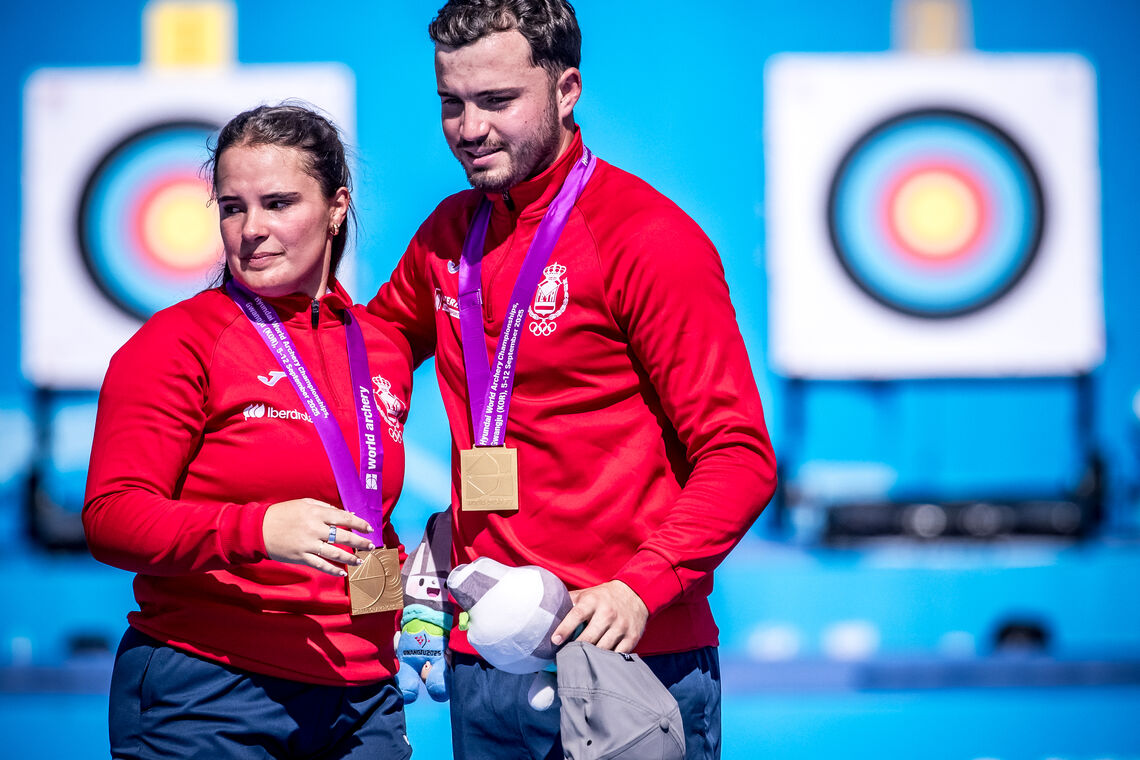 Elia Canales and Andres Temino Mediel on the podium after mixed team gold.