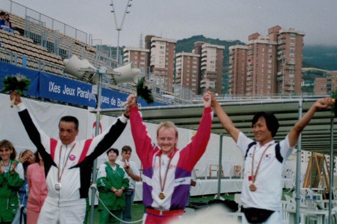 Kenichi Nishii, Jens Fudge and Cho Hyun Kwan celebrating Barcelona 1992 Paralympic medals.