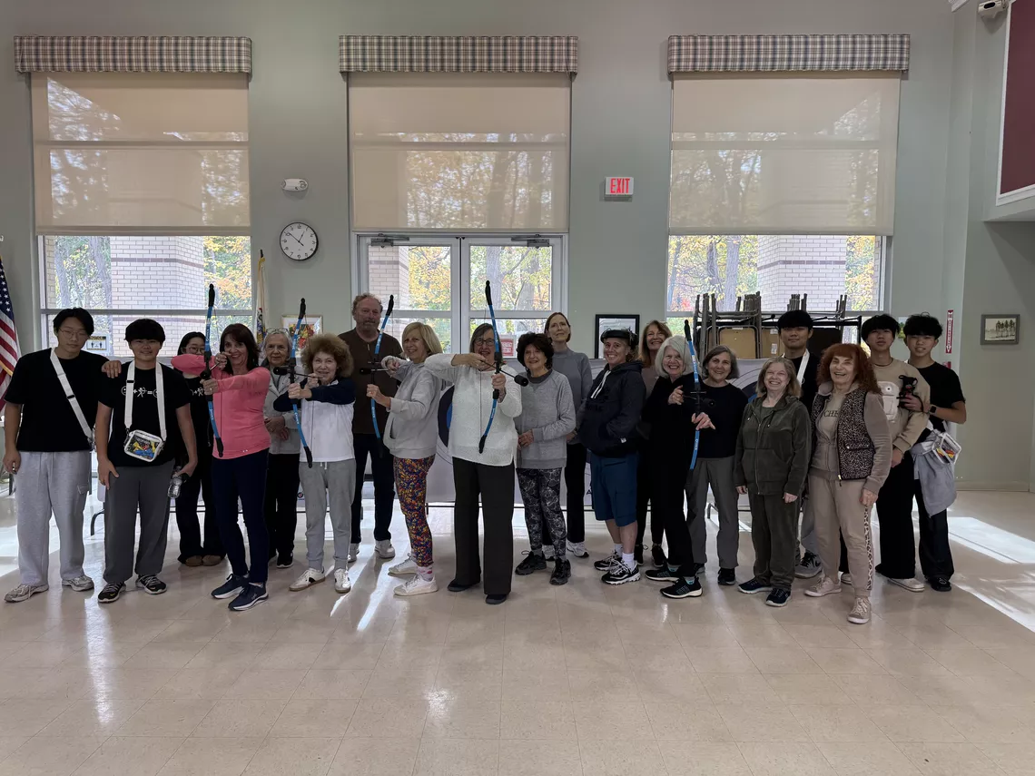 Group photo of Aim for Unity volunteers and seniors at the end of a workshop.