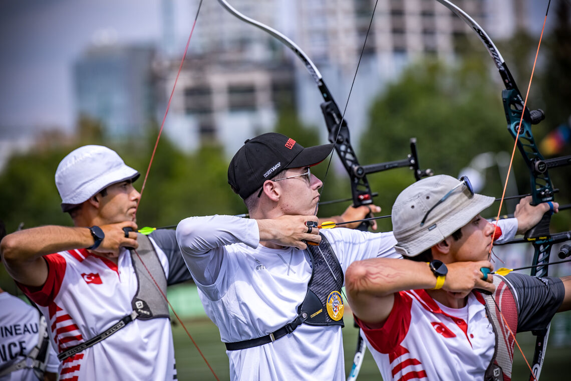 Baptiste Addis aiming inbetween two Turkish recurve men archers during qualifications at Puebla.