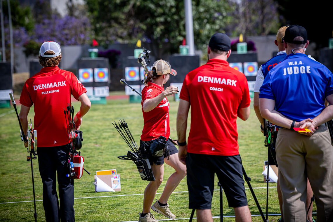 Mathias Fullerton and the Denmark coach watching Tanja Gellenthien shoot.