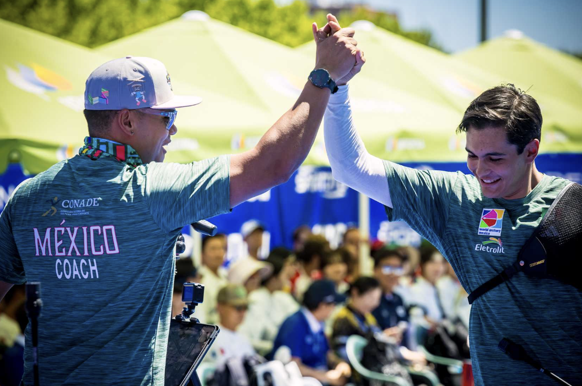 Matias Grande high fiving his coach.