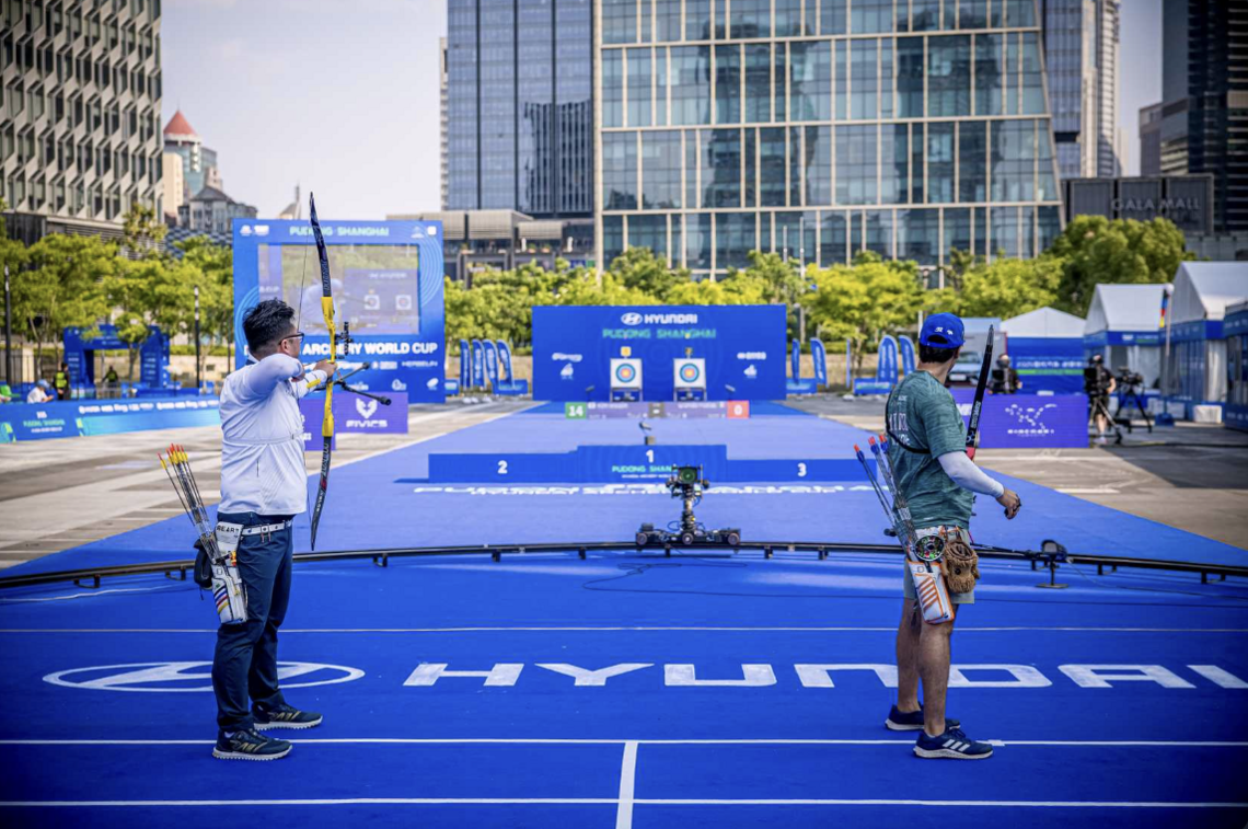 Kim Woojin and Matias Grande on the shooting line during the recurve men gold medal match at Shanghai 2025.