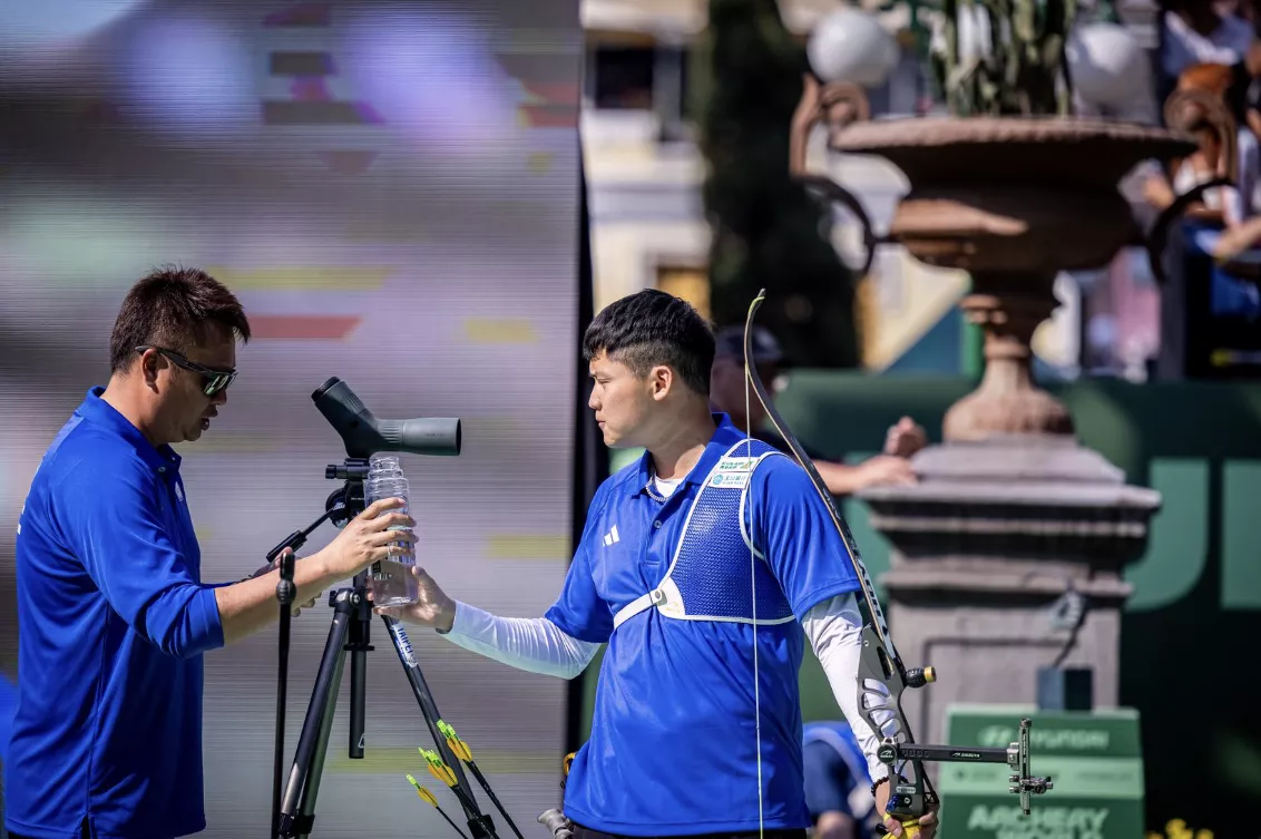 Tang Chih-Chun getting a water bottle from his coach during a match at Puebla 2026. 