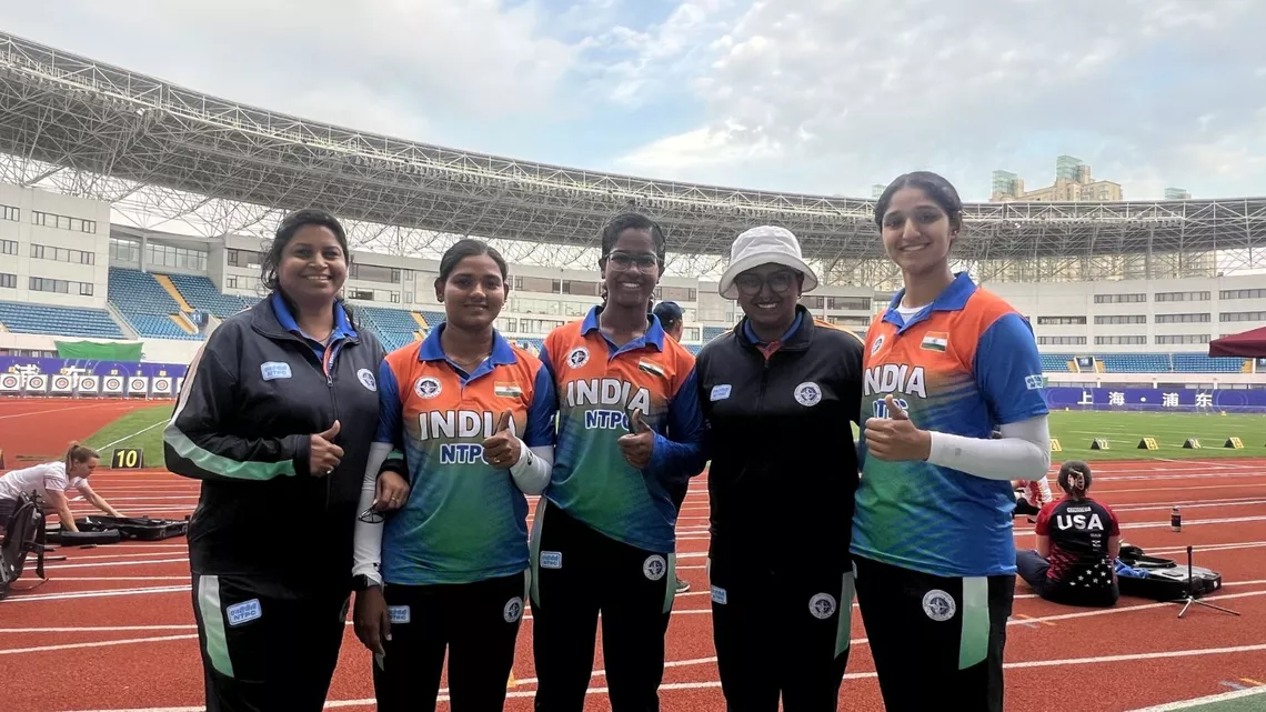 Archers pose with coach