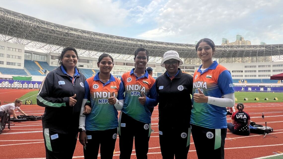 Archers pose with coach