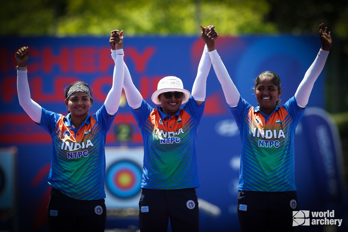 Arrchers pose on podium