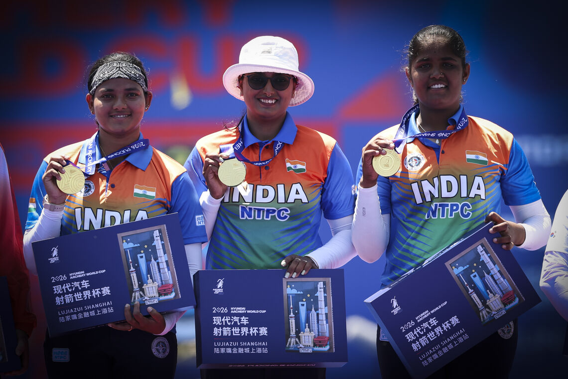 Archers pose on podium