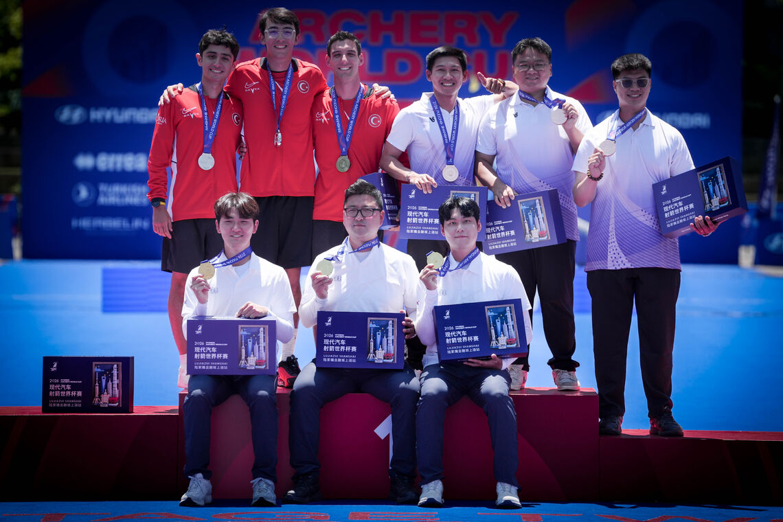 Archers pose on podium