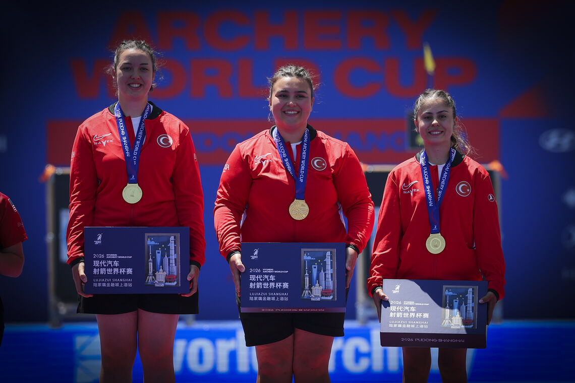 Athletes pose on podium