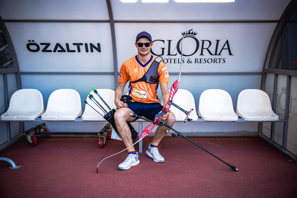 Willem Bakker sitting down at the Gloria Sports Arena with his bow.