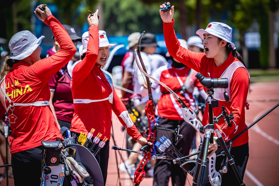 Jiaman, Yuwei and Jingyi with their hands in the air shouting during their semifinal match against Türkiye in the recurve women team event at Antalya 2026.. 