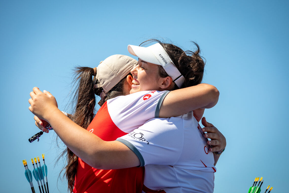 Yesim Bostan and Defne Cakmak embrace at the 14th Conquest Cup
