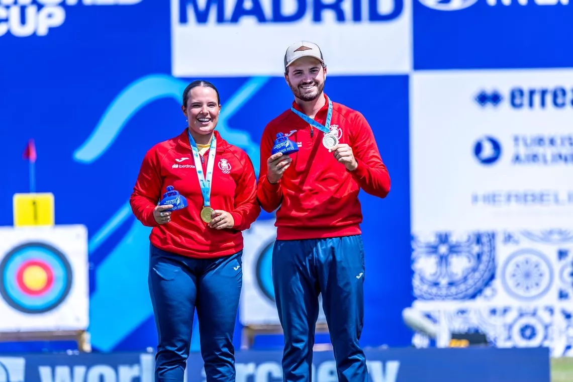 Elia Canales and Andres Temino Mediel on the recurve mixed team top podium at Madrid 2026.