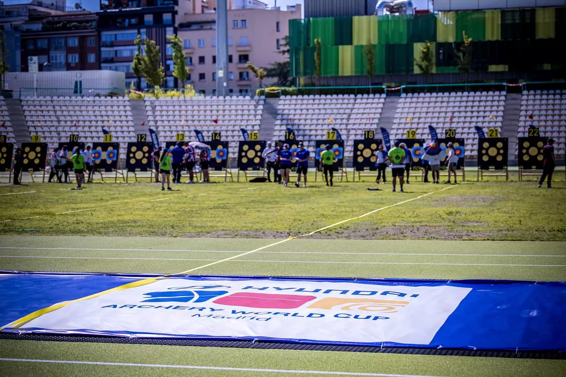 Landscape view of archers in the distance counting scores at target at Madrid 2025.