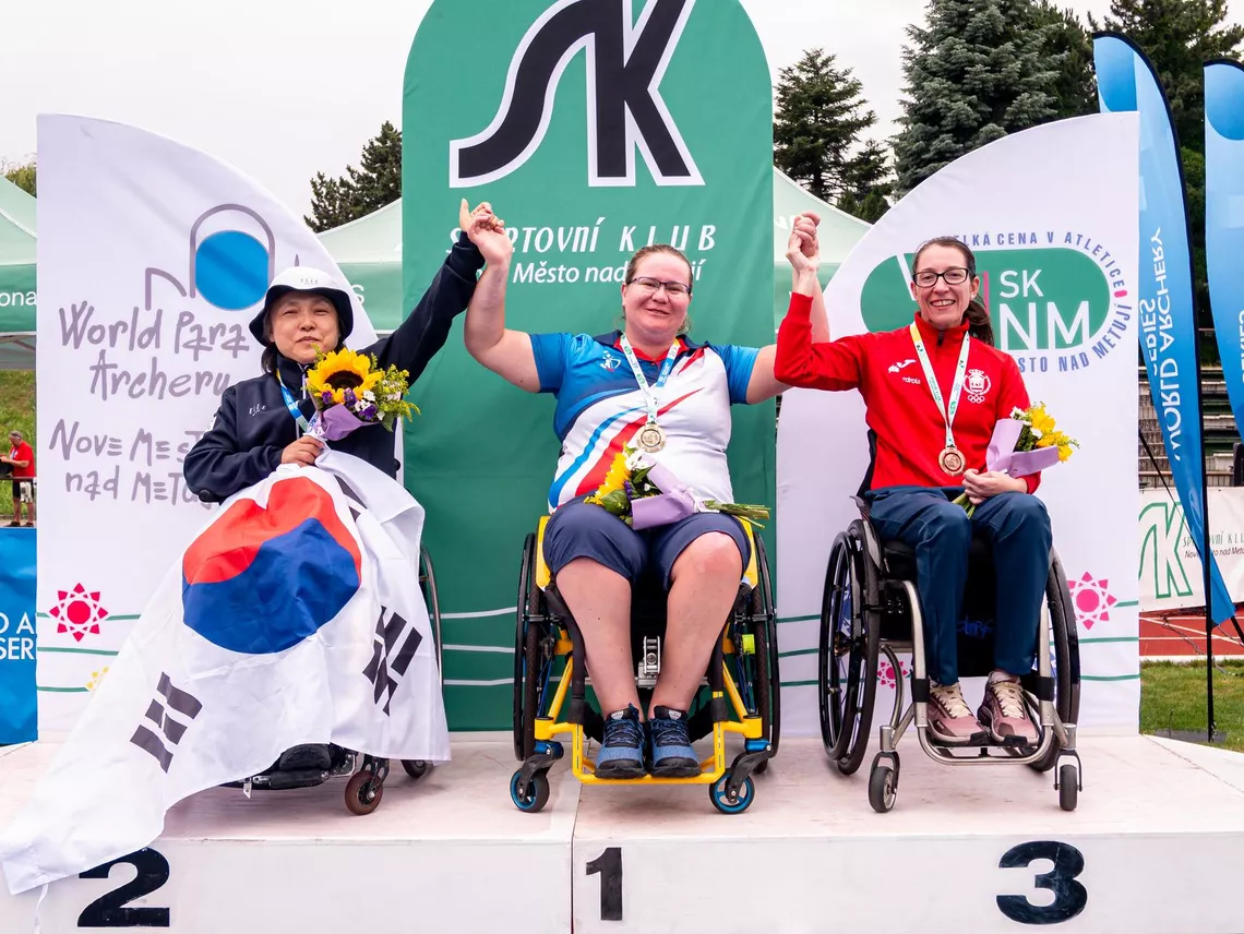 Archers pose on podium